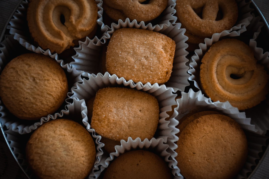 Assorted gourmet cookies arranged in a tin, styled as a cookie gift box for hosting season
