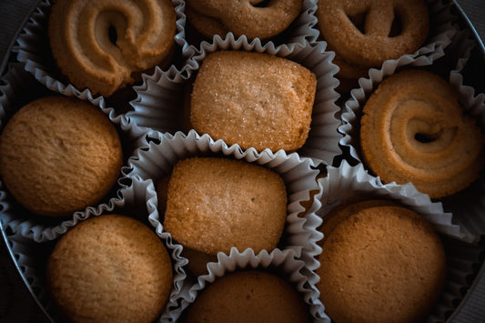 Assorted gourmet cookies arranged in a tin, styled as a cookie gift box for hosting season