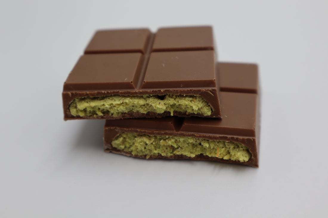 Close-up cross-section of a chocolate bar with thick pistachio filling, showing what an authentic Dubai chocolate bar looks like inside