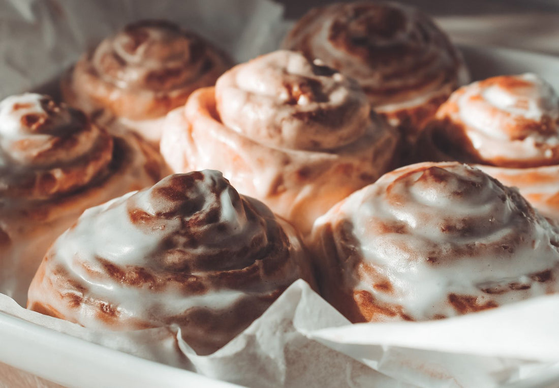 Freshly baked cinnamon rolls with glossy icing, close up — the base for a pistachio cinnamon rolls recipe made with pistachio cream