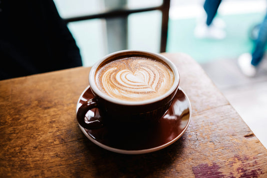Close-up of a Dubai chocolate latte with creamy foam in a warm brown cup