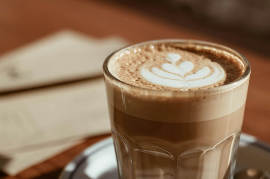 Dubai chocolate coffee latte topped with foam in a glass