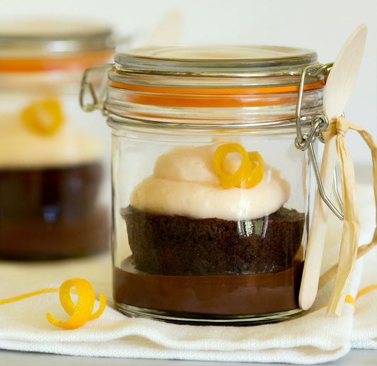 Layered cookie butter cheesecake jar dessert in a clear glass jar